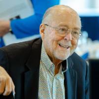 Guest sitting and talking with others at the Foundation Annual Meeting